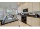 Updated kitchen with granite counters, white cabinets, modern appliances, and tile flooring at 6412 Golden Eye Gln, Lakewood Ranch, FL 34202
