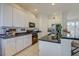 Spacious kitchen with granite countertops, white cabinets, stainless steel appliances, and tile flooring at 6412 Golden Eye Gln, Lakewood Ranch, FL 34202