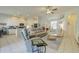 Open-concept living room featuring neutral decor, tile floors, and a ceiling fan at 6412 Golden Eye Gln, Lakewood Ranch, FL 34202