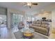 Bright living room featuring tile floors, comfortable sofas, and an open layout connecting to the kitchen and lanai at 6412 Golden Eye Gln, Lakewood Ranch, FL 34202