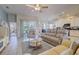 Open living space with tile flooring, comfortable furniture, and views of the kitchen and screened lanai at 6412 Golden Eye Gln, Lakewood Ranch, FL 34202