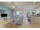 Bright, open living room with tile floors, ceiling fan, and a view of the kitchen bar and counter seating at 6412 Golden Eye Gln, Lakewood Ranch, FL 34202