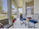 This is a cozy screened-in patio with comfortable seating and potted plants, perfect for outdoor relaxation at 6412 Golden Eye Gln, Lakewood Ranch, FL 34202