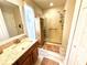 Bathroom featuring a glass enclosed shower, wood cabinets, and tile floors at 6442 Barberry Ct, Lakewood Ranch, FL 34202