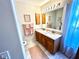 Well-lit bathroom featuring double sinks, granite counters, and wood cabinets at 6442 Barberry Ct, Lakewood Ranch, FL 34202