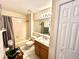 Bright bathroom featuring a shower/tub combo, granite counters, and wood cabinetry at 6442 Barberry Ct, Lakewood Ranch, FL 34202