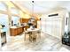 Spacious kitchen and dining area with vaulted ceilings, light colored floors, wood cabinets, and a dining table at 6442 Barberry Ct, Lakewood Ranch, FL 34202