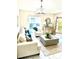 Bright living room with neutral colored couch, blue pillows and decor, an accent chair, and natural light at 6442 Barberry Ct, Lakewood Ranch, FL 34202