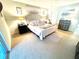 Calming main bedroom boasts a soft color palette, ceiling fan, and plush carpeting at 6442 Barberry Ct, Lakewood Ranch, FL 34202