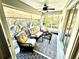Relaxing screened-in patio with comfortable seating, a ceiling fan, and views of lush landscaping at 6442 Barberry Ct, Lakewood Ranch, FL 34202