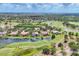 Picturesque aerial view featuring a beautiful golf course community with lakes and lush greenery at 7011 Portmarnock Pl, Lakewood Ranch, FL 34202