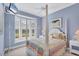 Cozy bedroom with bay window, ceiling fan, and colorful quilt at 7011 Portmarnock Pl, Lakewood Ranch, FL 34202