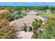 Well-manicured home featuring a brick driveway, three-car garage, and lush landscaping at 7011 Portmarnock Pl, Lakewood Ranch, FL 34202