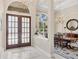Elegant foyer with marble floors, and an archway to the formal dining room at 7011 Portmarnock Pl, Lakewood Ranch, FL 34202