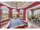 Spacious game room with a pool table, three arched windows and direct access to the screened patio at 7011 Portmarnock Pl, Lakewood Ranch, FL 34202