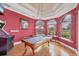 Vibrant game room features a pool table, hardwood floors, and arched windows, perfect for entertaining at 7011 Portmarnock Pl, Lakewood Ranch, FL 34202