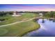 An aerial view of a scenic golf course, a lake and beautiful landscaping at 7011 Portmarnock Pl, Lakewood Ranch, FL 34202