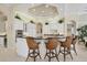 Bright and spacious kitchen with white cabinetry, island with seating, and modern appliances at 7011 Portmarnock Pl, Lakewood Ranch, FL 34202