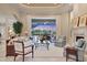 Bright living room with backyard pool view, fireplace, and comfortable seating at 7011 Portmarnock Pl, Lakewood Ranch, FL 34202