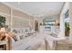 Elegant living room features neutral tones, tile floors, and custom built-ins, leading to a bright, airy space at 7011 Portmarnock Pl, Lakewood Ranch, FL 34202