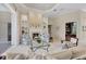Bright and open living room features a fireplace and access to the home office at 7011 Portmarnock Pl, Lakewood Ranch, FL 34202