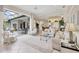 Bright living room with tile floors, comfortable seating, and sliding glass doors to the outdoor patio at 7011 Portmarnock Pl, Lakewood Ranch, FL 34202
