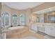 Bright bathroom with a soaking tub, vanity, and walk-in shower at 7011 Portmarnock Pl, Lakewood Ranch, FL 34202
