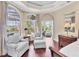 Bright main bedroom boasts large windows, sitting area, and hardwood floors at 7011 Portmarnock Pl, Lakewood Ranch, FL 34202