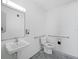 Commercial bathroom with sink, toilet, and accessible grab bars at 8100 Ciboney Ct # 11, Sarasota, FL 34240