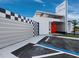 Building exterior with modern architecture, including a checkerboard wall design and covered parking spaces at 8100 Ciboney Ct # 11, Sarasota, FL 34240