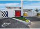 The building's entrance showcases a modern design with a bright red door and accessible parking spots at 8100 Ciboney Ct # 11, Sarasota, FL 34240