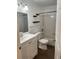 Bathroom with a sink, toilet, and shower featuring new tile and fixtures at 8617 Fancy Finch Dr # 102, Tampa, FL 33614