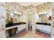 Spacious bathroom featuring dual vanities, floral wallpaper, and a separate toilet room at 8715 52Nd E Ave, Bradenton, FL 34211