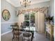 Elegant dining room features a glass table, chandelier, and sliders to lanai at 8715 52Nd E Ave, Bradenton, FL 34211