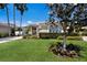 Charming single-story home featuring a lush green lawn, manicured landscaping, and a welcoming entrance at 8715 52Nd E Ave, Bradenton, FL 34211