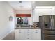 Bright eat-in kitchen featuring white cabinets, granite countertops, stainless steel fridge, and ample counter space at 8715 52Nd E Ave, Bradenton, FL 34211