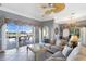 Comfortable living room featuring sliding glass doors to the pool area and stylish ceiling fan and chandelier at 8715 52Nd E Ave, Bradenton, FL 34211