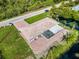 Aerial view of home with brick patio, screened in lanai, and lake views enhance outdoor appeal at 9080 Caloosa Dr, Venice, FL 34293