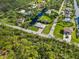Aerial view shows landscaping surrounding home, and canal views enhances outdoor appeal at 9080 Caloosa Dr, Venice, FL 34293