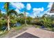 Beautiful backyard view from brick patio with serene canal views, enhancing the property's appeal at 9080 Caloosa Dr, Venice, FL 34293