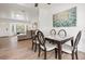 Elegant dining room with a glass-top table, stylish chairs, and wood flooring at 9080 Caloosa Dr, Venice, FL 34293