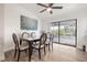 Bright dining room with a glass table, ceiling fan, and sliding door access to screened patio at 9080 Caloosa Dr, Venice, FL 34293