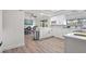 Modern white kitchen with stainless steel appliances and an adjacent dining area at 9080 Caloosa Dr, Venice, FL 34293