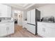 Updated kitchen featuring white cabinets, stainless appliances, and modern countertops at 9080 Caloosa Dr, Venice, FL 34293