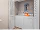 Laundry room features washer, dryer, and folding closet behind louvered doors at 9080 Caloosa Dr, Venice, FL 34293