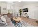 Bright and open living area with modern furnishings, wood floors, and a view to the kitchen at 9080 Caloosa Dr, Venice, FL 34293