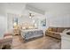 Bright main bedroom featuring a ceiling fan, seating area, and neutral décor at 9080 Caloosa Dr, Venice, FL 34293