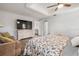 Bright main bedroom featuring a large television, seating area, and neutral décor at 9080 Caloosa Dr, Venice, FL 34293