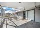 Enclosed patio featuring tile floors, clear panel windows, and outdoor seating at 9080 Caloosa Dr, Venice, FL 34293