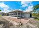 A screened porch is adjacent to a brick patio, providing an ideal transition to outdoor living at 9080 Caloosa Dr, Venice, FL 34293
